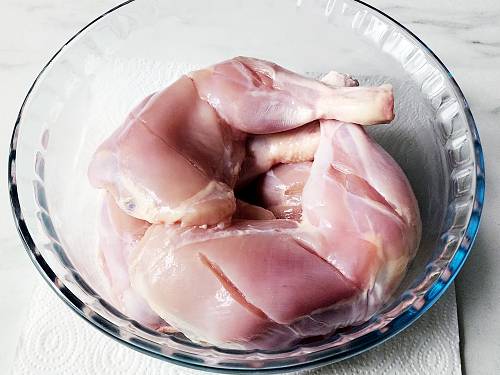 bone-in chicken with gashes, kept in a bowl