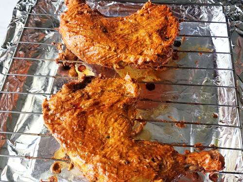 basting the chicken with chili oil