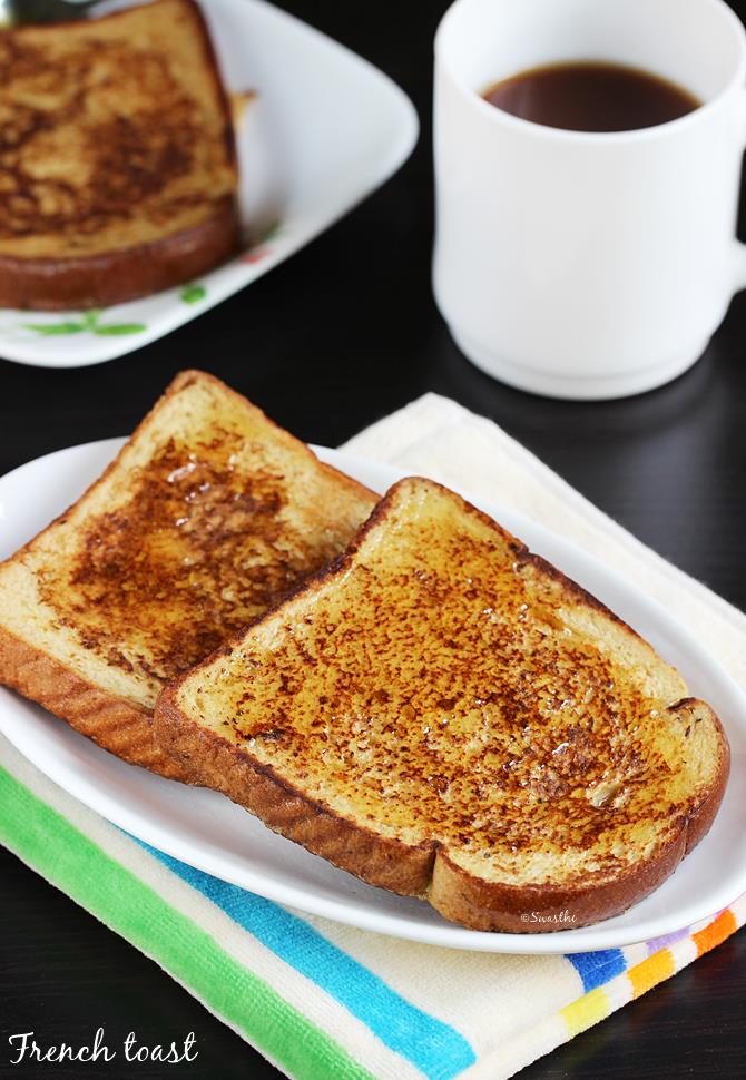 french toast topped with maple syrup, served in a white plate