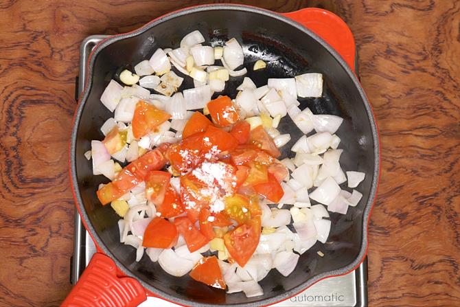 adding onions tomatoes to fry