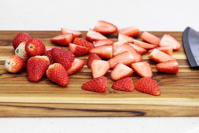 sliced strawberries on a chopping board