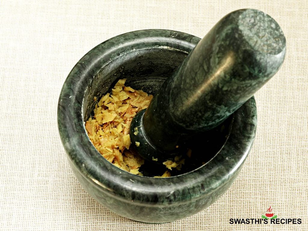 Crushed ginger using stone mortar pestle