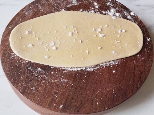 sprinkle of flour and ghee on rolled dough